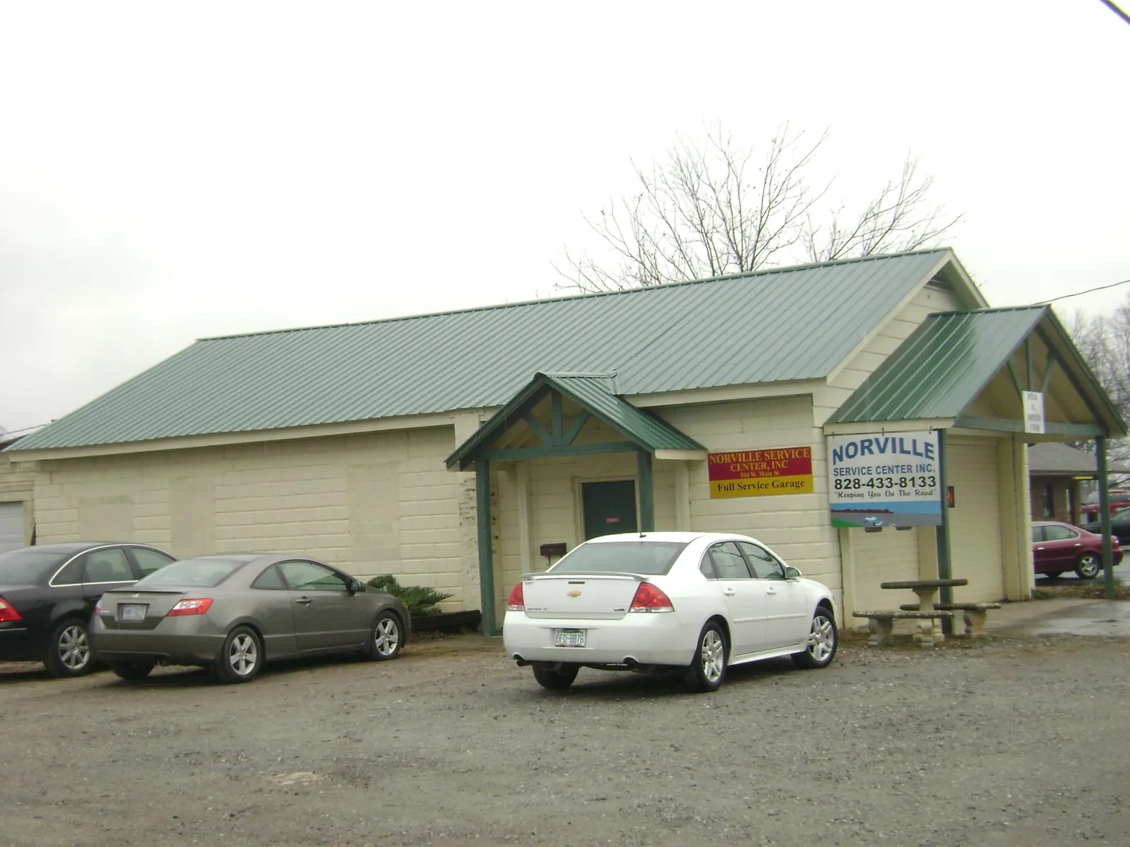 Green metal roof on a service garage with a covered entry in Albany